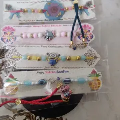 Here is another look at the variety of rakhis I offer, all packaged and ready for the festival. You can see the different styles, from cartoon characters to more traditional evil eye designs.
