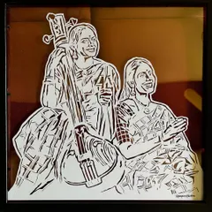 This angled shot shows how the paper-cut art sits between the two glass panes. This creates a sense of depth that you can't get with a traditional frame.