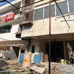 The site before construction, filled with debris. This image provides a stark contrast to the finished luxury residence.