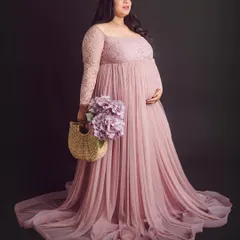 A full-length portrait showcasing the delicate lace details and flowing skirt of this popular pink gown from our client closet.