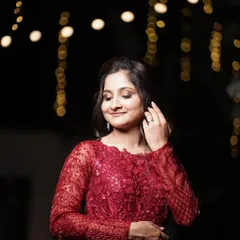 Monica looking absolutely dreamy for her reception. The soft, romantic makeup with a touch of shimmer on the eyes perfectly complements the magical, fairy-light ambiance.