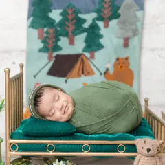 That sleepy smile is just priceless! I love capturing these fleeting expressions while babies dream during their newborn session.
