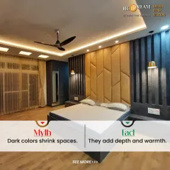 This image debunks the myth that dark colors shrink spaces. Here, a dramatic accent wall in shades of dark blue and gold adds depth, warmth, and a touch of moody sophistication to the bedroom.