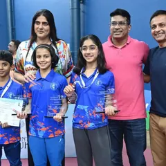 Young champions pose with their trophies alongside our management team. Celebrating the success of emerging talent is a highlight of our event management services for junior badminton.
