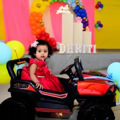 Kids' parties are all about fun. Here, the birthday girl enjoys her toy car, providing a great opportunity for a playful and colorful photograph that adds variety to the event album.