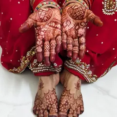 My mother's hands and feet, beautifully adorned with mehndi for the Chhath Puja festival.