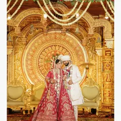 A timeless portrait of the bride and groom against a grand, traditional wedding backdrop. We are experts in capturing the elegance of indoor ceremonies.