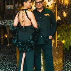 The hosts of the 'Gilded Instinct' party, perfectly dressed to match the glamorous, wild theme of the event.
