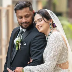 A quiet moment of connection. The bride rests her head on the groom's chest, a simple gesture that speaks volumes about their comfort and love for each other.