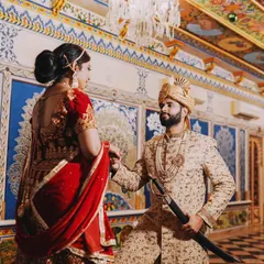 Capturing the grandeur of a royal courtship. Here, the groom kneels before his bride in a stunning palace hallway, a gesture that combines tradition with timeless romance against a backdrop of intricate blue and white designs.