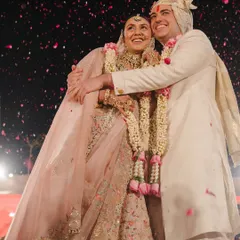 A shower of confetti and a hug full of joy. This shot captures the peak energy of the reception, a moment of pure celebration and happiness.