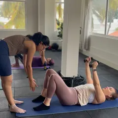 Here I am helping a client with her form during a chest lift with light dumbbells. I provide personalized attention in my group classes to ensure everyone is moving safely and getting the most out of each exercise.