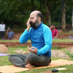 A participant practices Nadi Shodhana pranayama, or alternate nostril breathing. This is a core technique we teach in our Happiness Program to balance the mind, calm the nervous system, and improve focus.