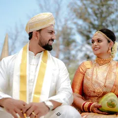 A candid moment between a bride and groom during their South Indian wedding ceremony, sharing a look of love and happiness.