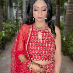 Our beautiful Garhwali bride glowing on her engagement day. The soft glam makeup and open hairstyle perfectly suited her red outfit.