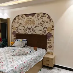 For this bedroom, I created a custom headboard effect by installing a floral wallpaper within an arched shape on the wall.