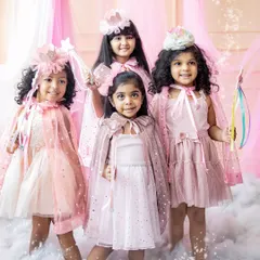 Bibbidi-bobbidi-boo! This magical fairy-themed shoot was an absolute dream. These four little fairies, dressed in beautiful capes and holding wands, look like they've stepped right out of a storybook.