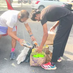 Sorting through donated running shoes and gear for needy players. Every contribution helps us support another athlete on their journey.