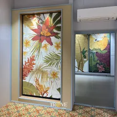 Make a bold statement with a tropical floral mural. This large format tile art brings vibrant color and life to the space, acting as a stunning focal point that connects with the patterned floor tiles.