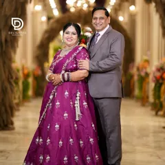 A classic portrait of the happy couple at their 25th anniversary party. Their smiles show a love that has deepened and grown stronger over the years.