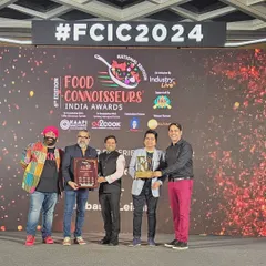 Our team on stage receiving multiple awards at the Food Connoisseurs India Awards 2024.