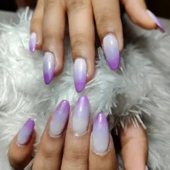 A soft and dreamy purple and white ombre on long, oval-shaped nails. A perfect way to add a pop of color while keeping it elegant.