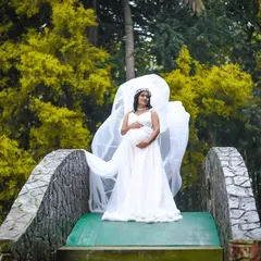 A dynamic shot showing the beautiful movement of the white gown's sheer train. I help style these moments to add a touch of magic to your maternity photos. This is perfect for clients wanting an ethereal, goddess-like feel for their shoot.