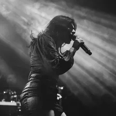A dramatic black and white shot of me lost in the music during a TS Collective show. This photo captures the raw emotion and passion I pour into performing my original songs.