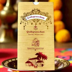 This traditional 'Gruhapravesham' invitation features classic motifs like a kalash and Ganesha, perfect for an auspicious new beginning.