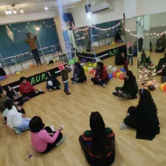A wide view of a New Year's get-together, with guests seated in a circle for a party game. This shows how the large floor area can be used for interactive group activities during events.