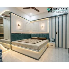 This bedroom at Lodha Belair showcases classic wall paneling above a teal upholstered headboard. Integrated wall sconces and under-bed lighting create a warm, layered glow, perfect for a relaxing ambiance.