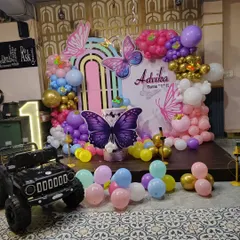 A wider view of the butterfly birthday setup, which also included a mini toy jeep for the birthday girl's grand entrance.