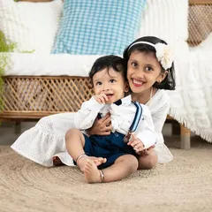 A sweet moment between an older sister and her baby brother. We love capturing the beginning of a lifelong friendship during our sibling and family photoshoots.