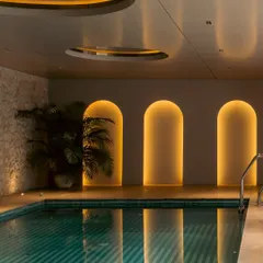 This basement pool area was designed as an unexpected, indulgent escape. The warm glow from the arched niches reflects on the water, creating an immersive retreat that feels both modern and timeless.