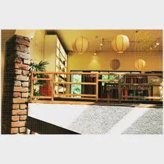 Natural light floods this retail interior through a central courtyard. The design uses simple, natural materials like brick and wood to create a warm and inviting shopping experience, proving that commercial spaces can feel organic and light.