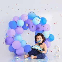 A messy and happy two-year-old enjoying his birthday cake. Our cake smash sessions are all about capturing the fun and personality of your toddler.