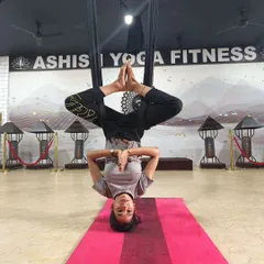 Finding stillness and balance while inverted in the silk hammock. This pose strengthens the core and improves focus, all while being fully supported.