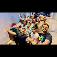 A mirror selfie of a happy group after a weekend fitness workshop. The full-wall mirror is not just for checking form, it's also perfect for capturing those memorable group moments.