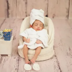 This little one is fully relaxed, complete with a robe, towel, and slippers. The 'Infant Spa Day' is one of my most requested creative newborn sessions.