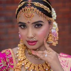 A detailed view of our bridal matha patti and choker set. The antique finish and red stone accents are perfect for a classic wedding look.