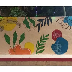This long wall features an abstract design combining organic leaf shapes with bold, colourful blocks. It's a modern take on a botanical theme.