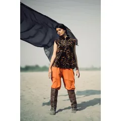 Another shot from the same outdoor series, this time with the model holding a flowing black fabric. The movement in the fabric adds a dynamic and ethereal quality to the fashion photograph.