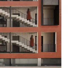 A detail of the facade showing the rhythmic pattern of the staircase screens. The vertical fins provide privacy and diffuse light, creating a dynamic interplay of light and shadow across the building's exterior.