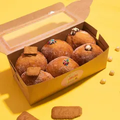 A box of my assorted Italian Stuffed Donuts, also known as bombolonis. Flavors include Blueberry Cheesecake, Chocolate Ganache, Bitchy Biscoff, Naughty Nutella, Coffee, and Salted Caramel.