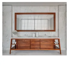 A custom-designed vanity in the Bombay Penthouse. The combination of salvaged teak, white Bhanswara marble, and a clean, mid-century inspired design creates a sense of peaceful, elemental luxury.