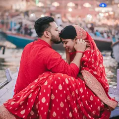 This pre-wedding shoot on the ghats of Varanasi was about finding a quiet moment of connection amidst the city's eternal rhythm. The groom's gentle kiss and the bride's serene smile tell a story of love against a backdrop of timeless tradition.