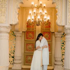 A quiet embrace in a royal setting. This shot captures the luxury and intimacy of a destination pre-wedding shoot, with the grandeur of the palace architecture framing a deeply personal moment.