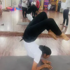 An incredible display of strength and flexibility in Vrischikasana, the scorpion pose. This is an advanced inversion that we help our dedicated students work towards.