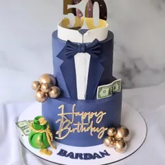 Cheers to 50! This two-tier tuxedo cake in a striking navy blue is perfect for a milestone birthday, complete with a bow tie and a bag of money.