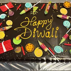 Light up your office Diwali party with our Diwali Dhamaka Cake. This large chocolate cake is decorated with edible firecrackers, making it a fun and festive centerpiece.